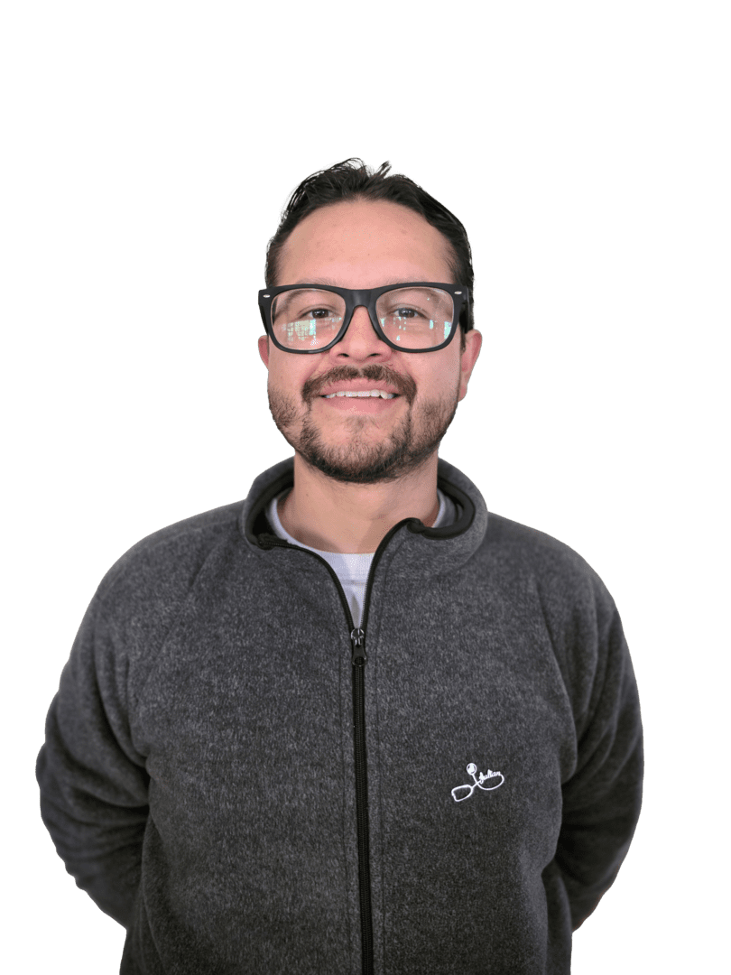 Retrato de Julián David Acuña Jaimes sonriendo, con gafas y chaqueta gris, para perfil del equipo docente.